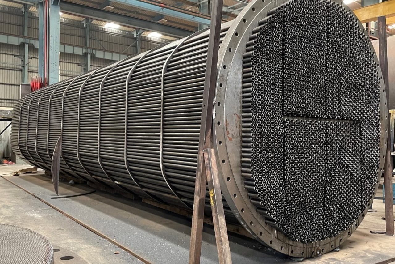 Massive industrial heat exchanger; heavy metallic piping and grid structures; mass arresting thermodynamic flow.