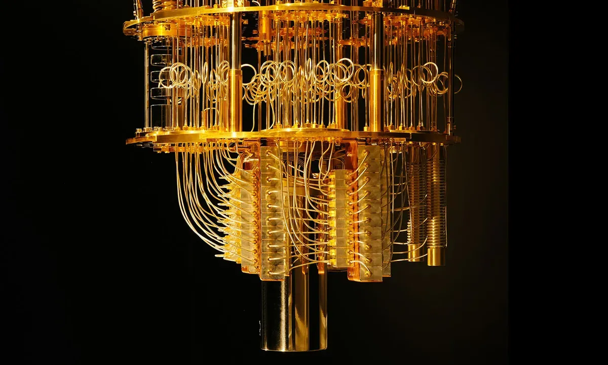 Gold and copper quantum computer dilution refrigerator; complex suspended computing chandelier; isolated anechoic chamber setting.